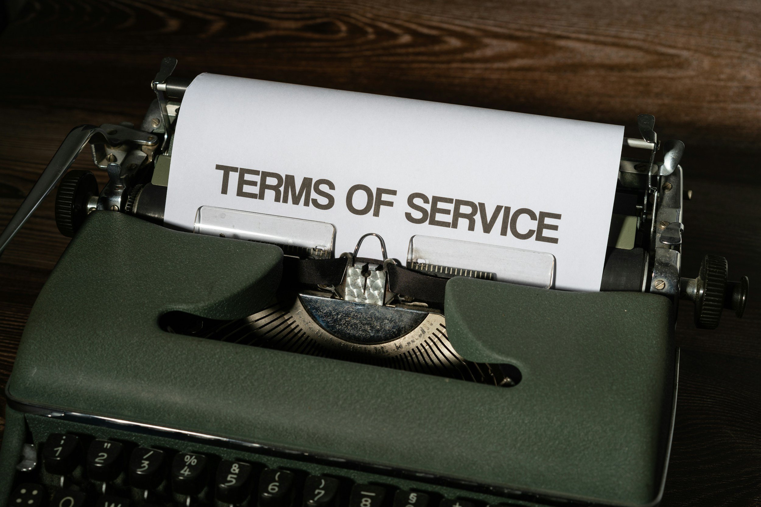 Typewriter with a sheet of paper that says 'TERMS OF SERVICE' on it.